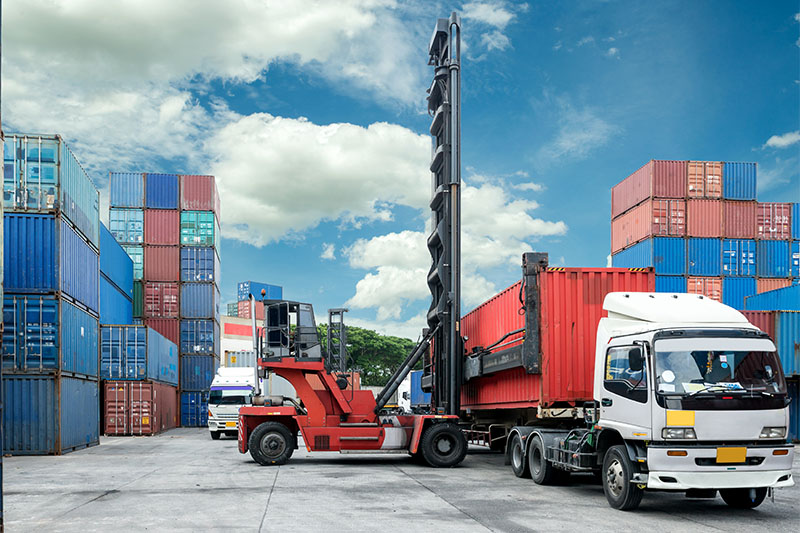 Forklift lift container box loading to truck in depot use for import export logistic background