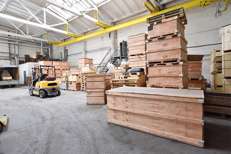 Large and light warehouse, cargo storage in wooden boxes.